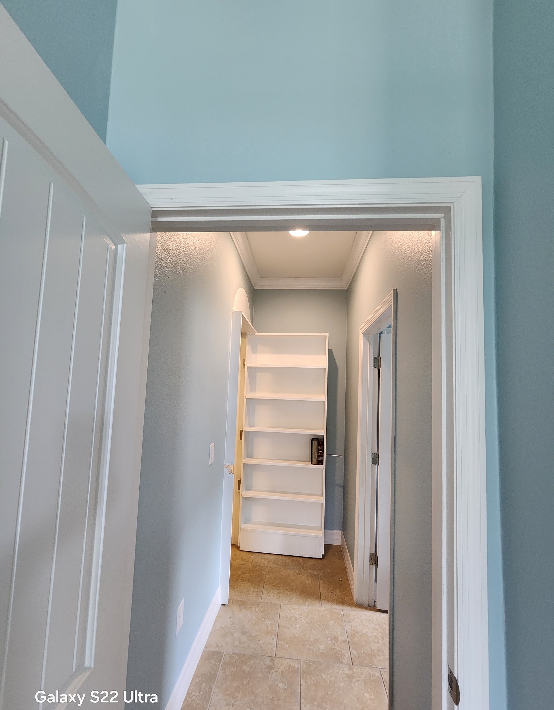 Light blue hallway walls and white trim freshly painted