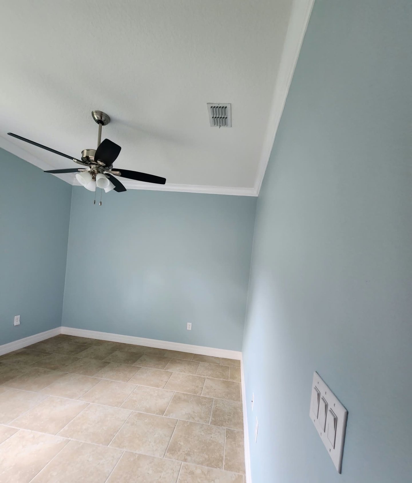 Bedroom freshly painted soft coastal blue with crisp white trim